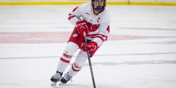 Caroline Harvey carries the puck for the University of Wisconsin women's hockey team