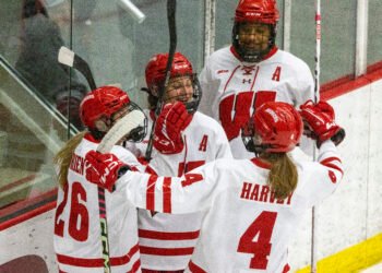 Lacey Eden, Casey O'Brien, Laila Edwards, and Caroline Harvey celebrate a Wisconsin goal