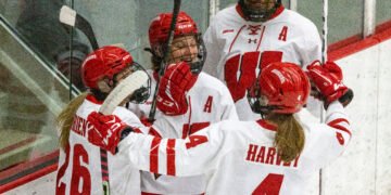 Lacey Eden, Casey O'Brien, Laila Edwards, and Caroline Harvey celebrate a Wisconsin goal