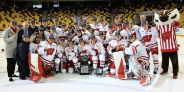 The Wisconsin Badgers women's hockey team celebrates their 2025 WCHA title. They enter the 2025 NCAA women's hockey national championships as the top seed - Photo @ Wisconsin Athletics