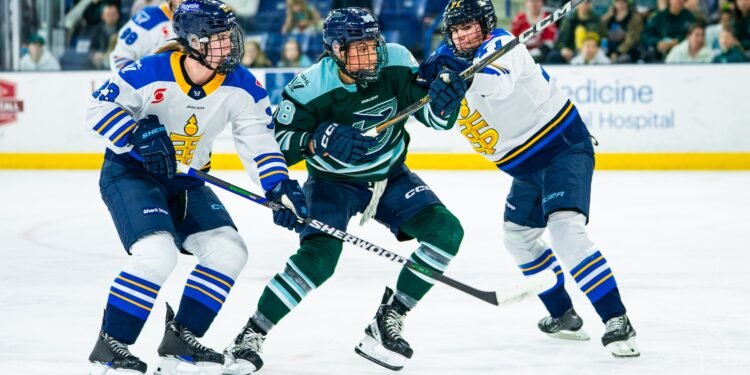 Lexie Adzija looks to push through a pair of Toronto Sceptres players - Photo @ PWHL